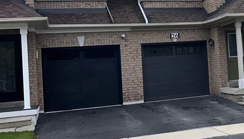 Dual deep red garage doors with lighting accents