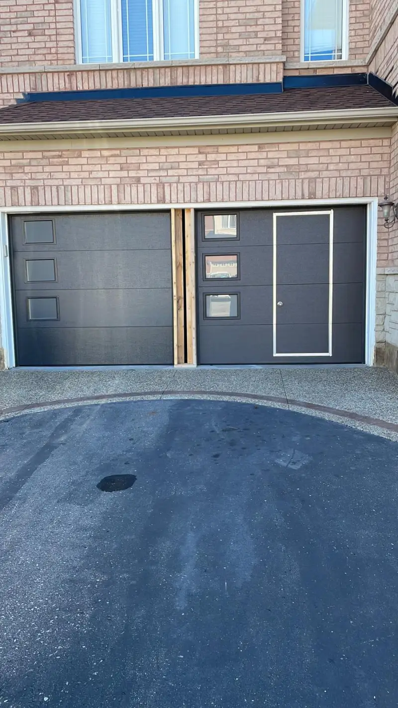 Aluminum and glass garage door with exterior lighting